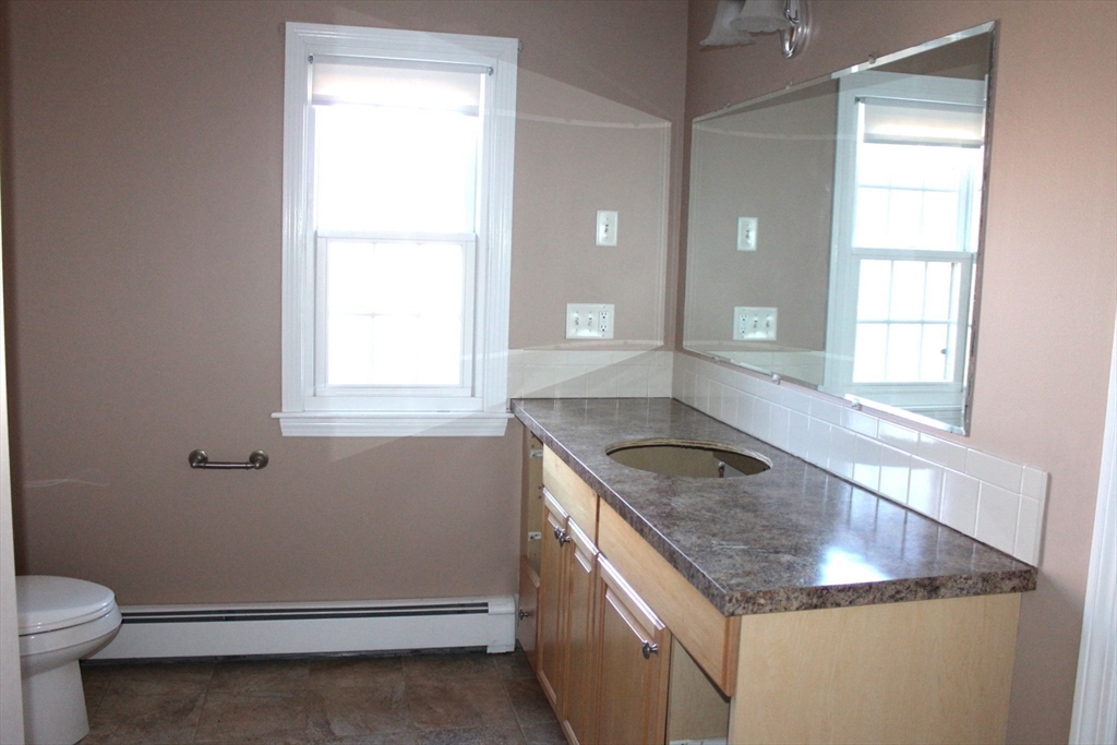 700 Wrentham Road, Unit 2 Bellingham, MA 02019 - Photo 19 of 23 a kitchen with a sink stove and cabinets