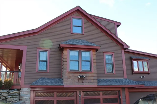 a brick building that has two windows on it