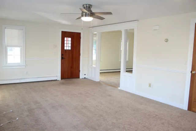 an empty room with closet and windows