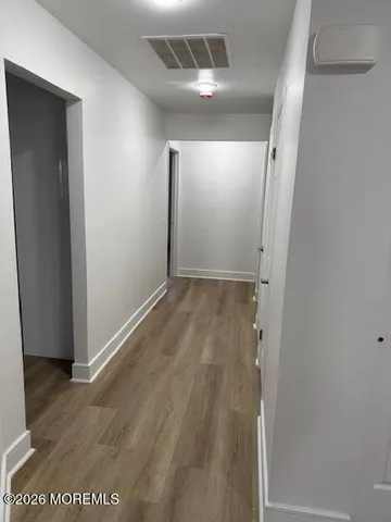 an empty room with wooden floor