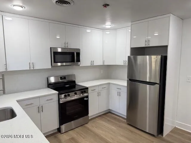 a kitchen with a refrigerator stove and microwave