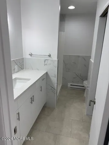 a bathroom with a granite countertop sink and a mirror