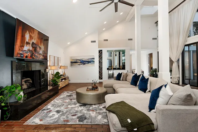 a living room with furniture and a fireplace