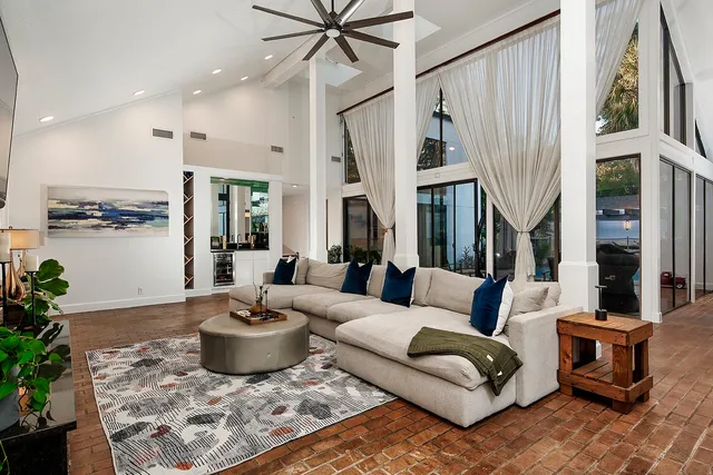 a living room with furniture and a potted plant