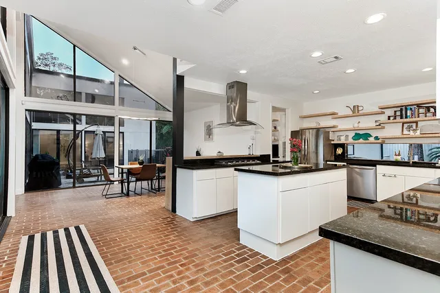 a kitchen with stainless steel appliances granite countertop a sink and a stove