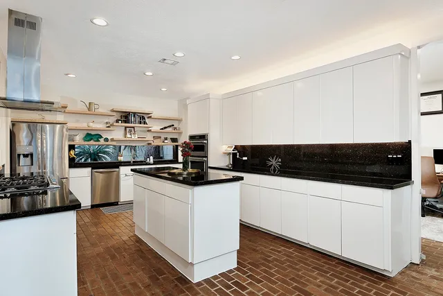 a kitchen with stainless steel appliances and white cabinets