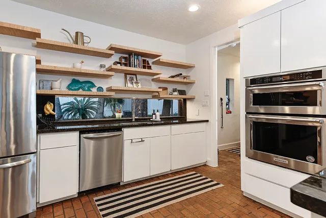 a kitchen with stainless steel appliances a stove and a refrigerator