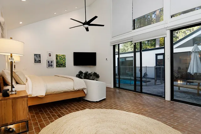 a bed room with a bed and a television