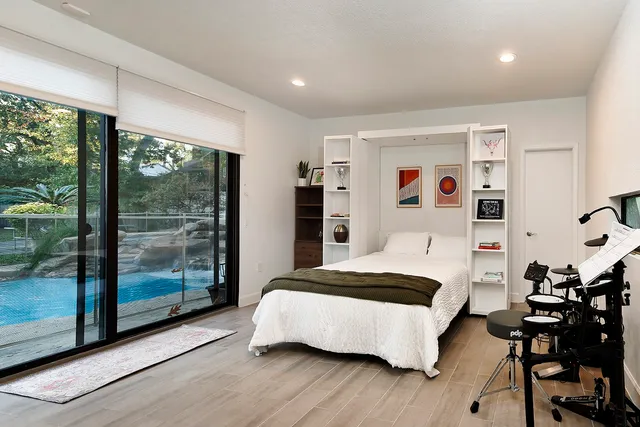 a bedroom with a bed and wooden floor