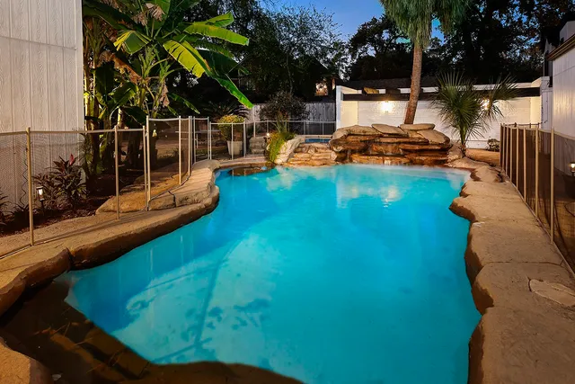 a view of a living room with furniture and floor to ceiling windows