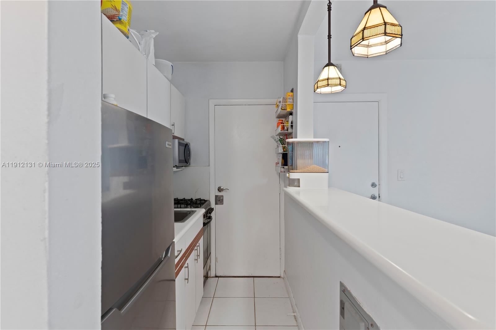 6310 Southwest 79th Street, Unit 1 South Miami, FL 33143 - Photo 1 of 10 a kitchen with a refrigerator and a sink