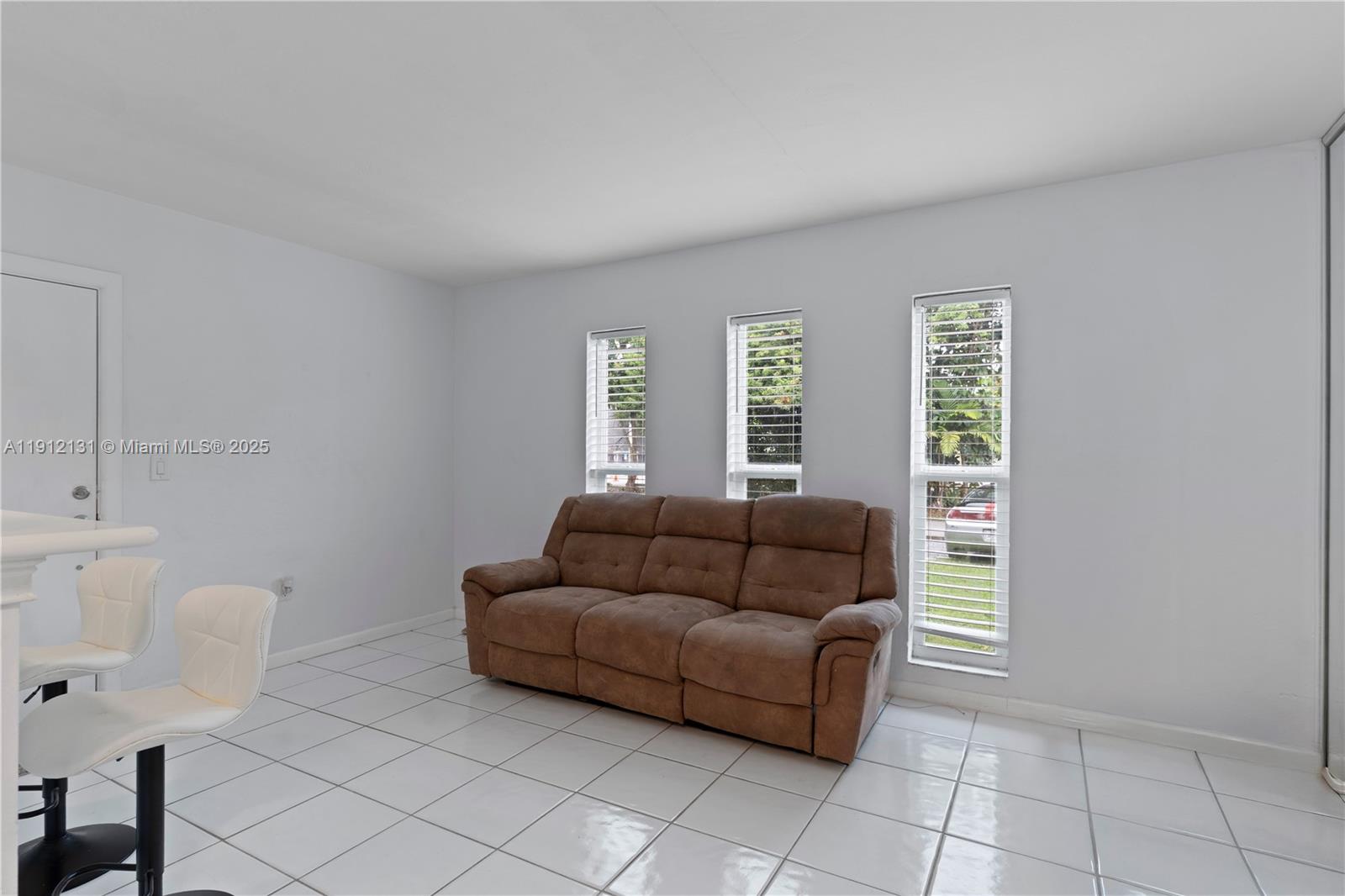 6310 Southwest 79th Street, Unit 1 South Miami, FL 33143 - Photo 5 of 10 a living room with furniture and a window