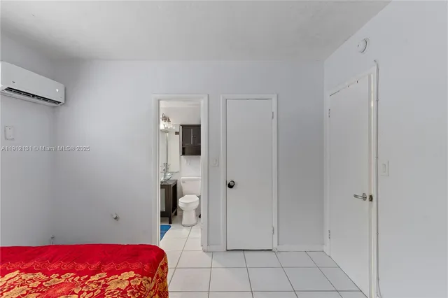 a bedroom with a bed and a view of bathroom