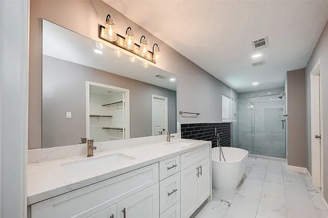 a bathroom with a shower and a sink