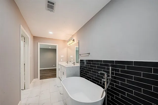 a bathroom with a double vanity sink a mirror and a shower