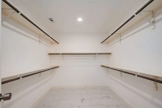 an empty room with a ceiling fan and a window