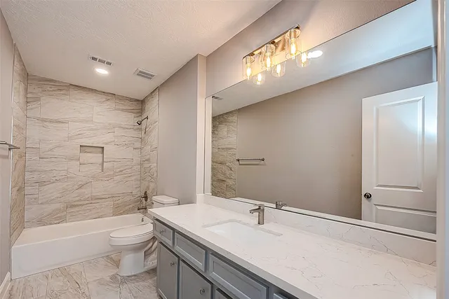 a bathroom with a bathtub and a toilet