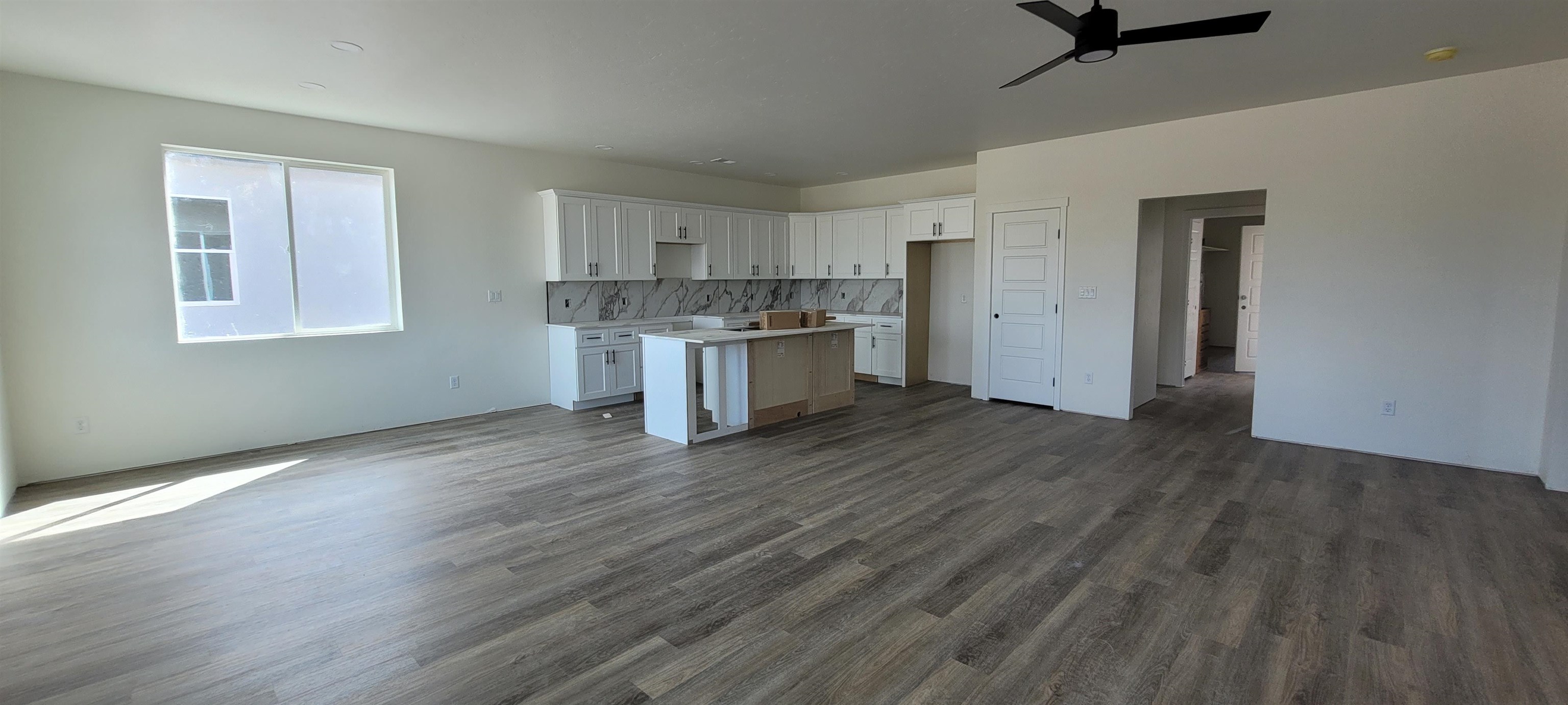 1644 Tungsten Way Fruita, CO 81521 - Photo 2 of 17 a kitchen with a sink and wooden floor