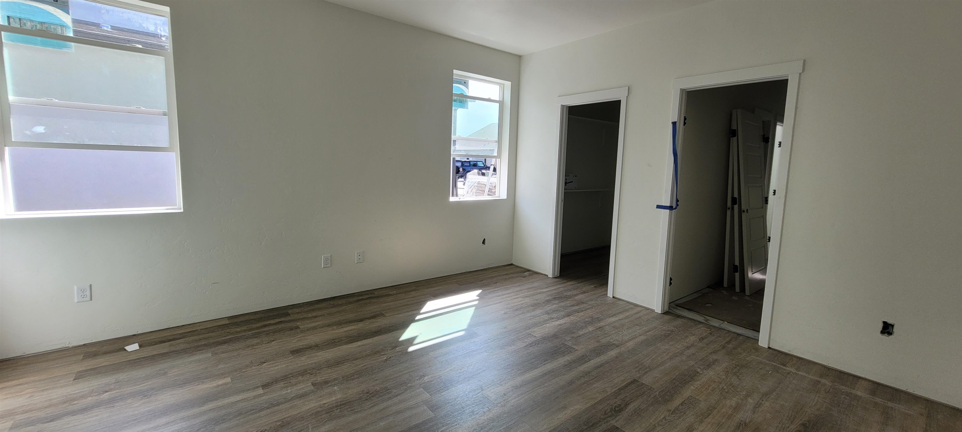 1644 Tungsten Way Fruita, CO 81521 - Photo 7 of 17 an empty room with wooden floor and windows