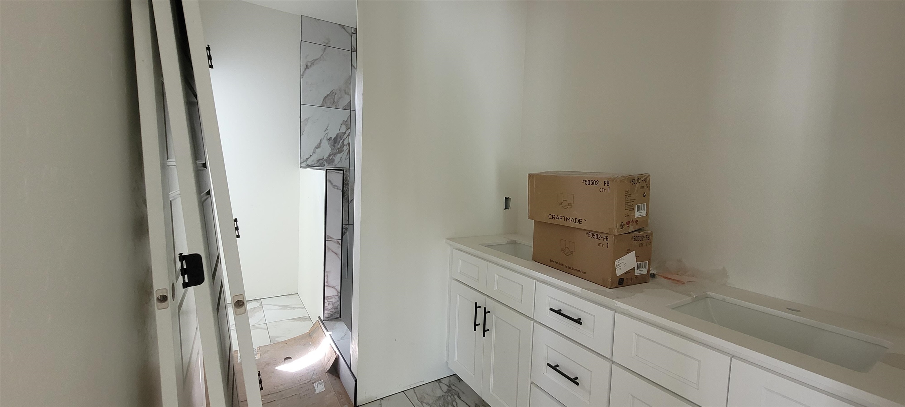 1644 Tungsten Way Fruita, CO 81521 - Photo 8 of 17 a bathroom with a sink and glass door