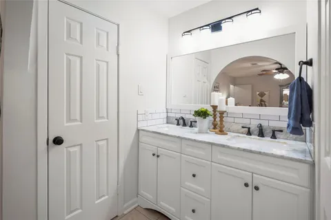 a bathroom with a double vanity sink and a mirror