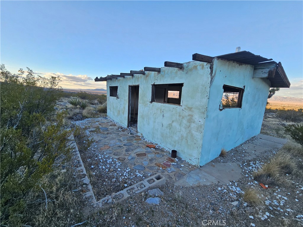411 Powerline Road Lucerne Valley, CA 92356 - Photo 1 of 10 a view of a house with a backyard