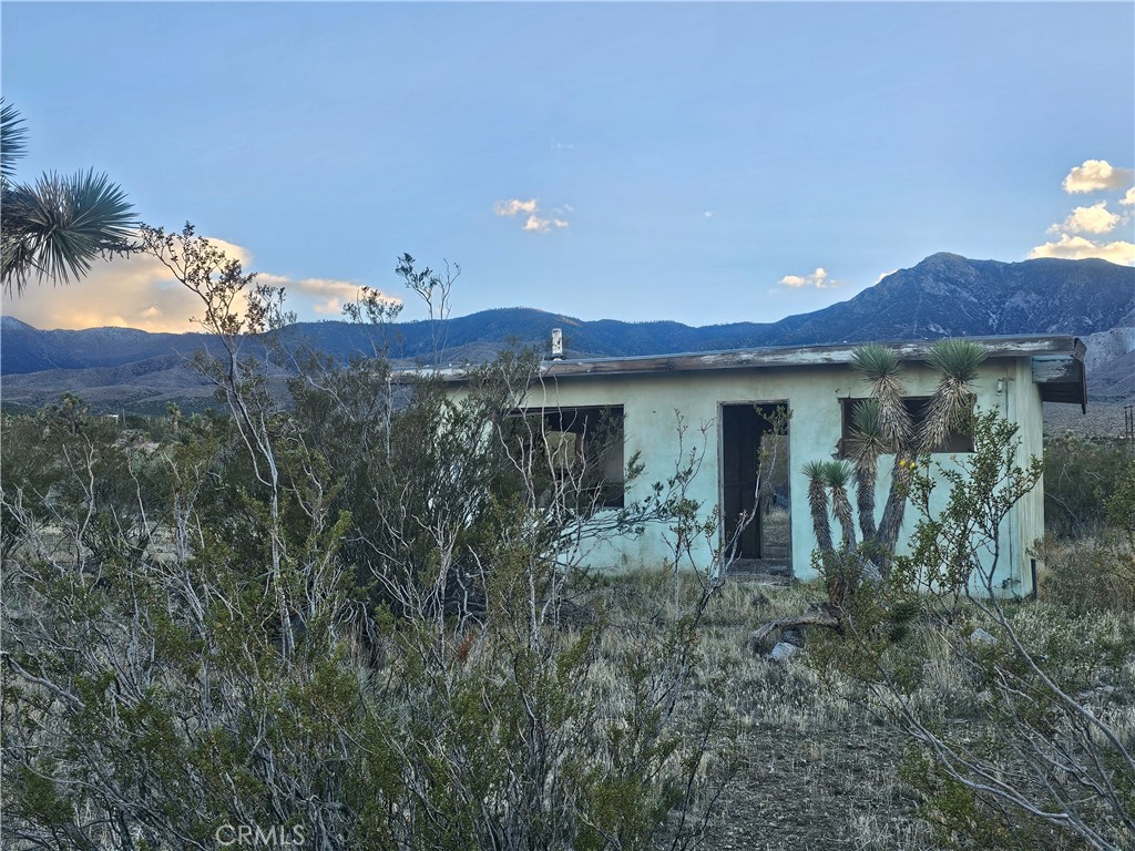 411 Powerline Road Lucerne Valley, CA 92356 - Photo 2 of 10 a view of a house with a yard
