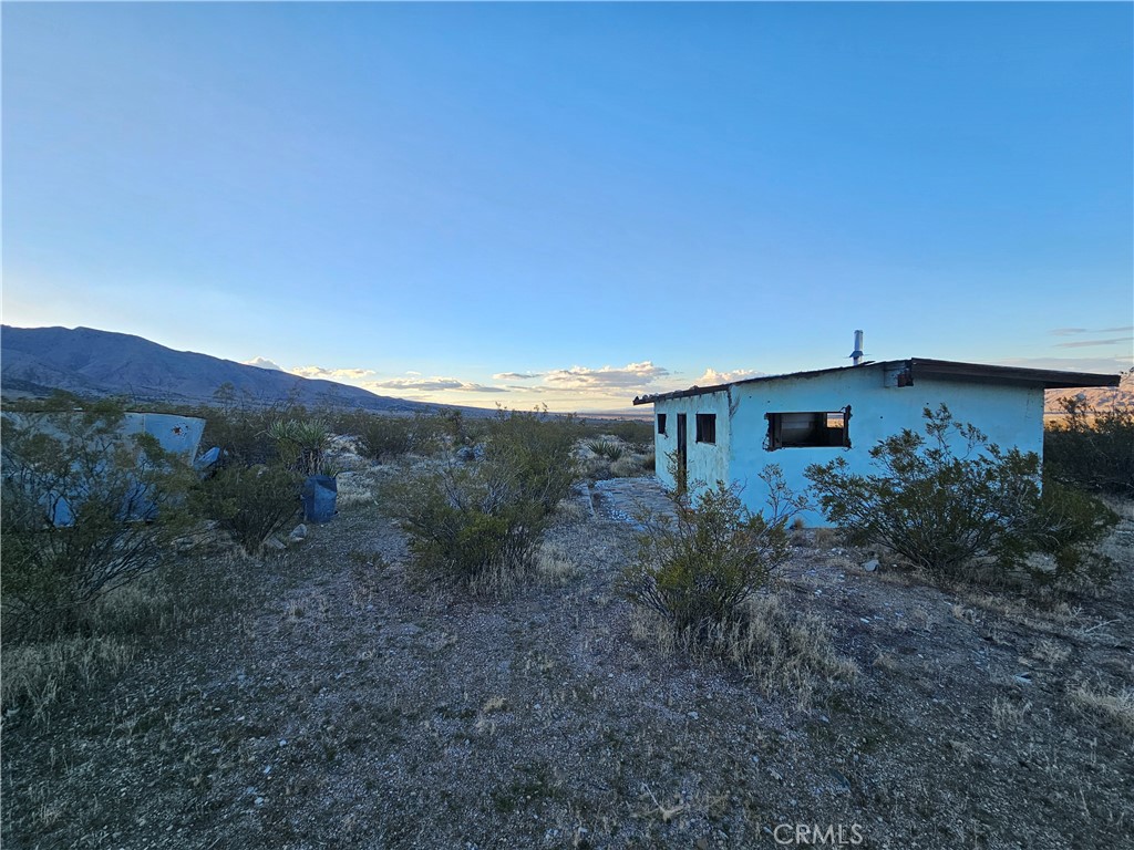 411 Powerline Road Lucerne Valley, CA 92356 - Photo 3 of 10 a view of a house with a yard