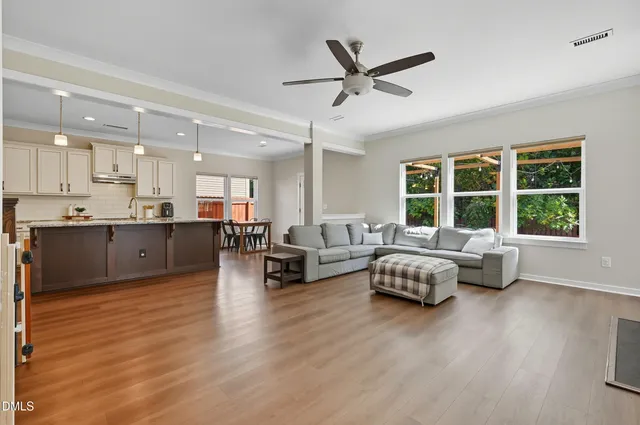 a living room with furniture and window with wooden floor