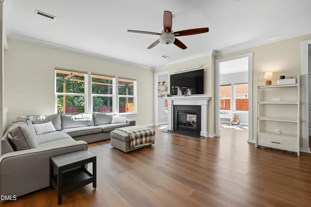 a living room with furniture flat screen tv and a fireplace