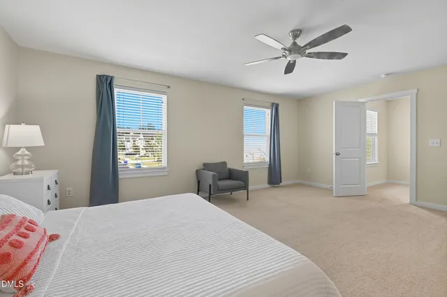 a bedroom with a large bed and a window