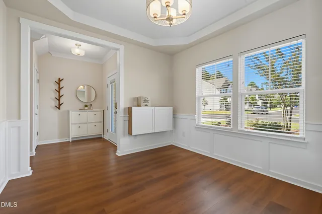 a view of a livingroom with wooden floor and cabinet