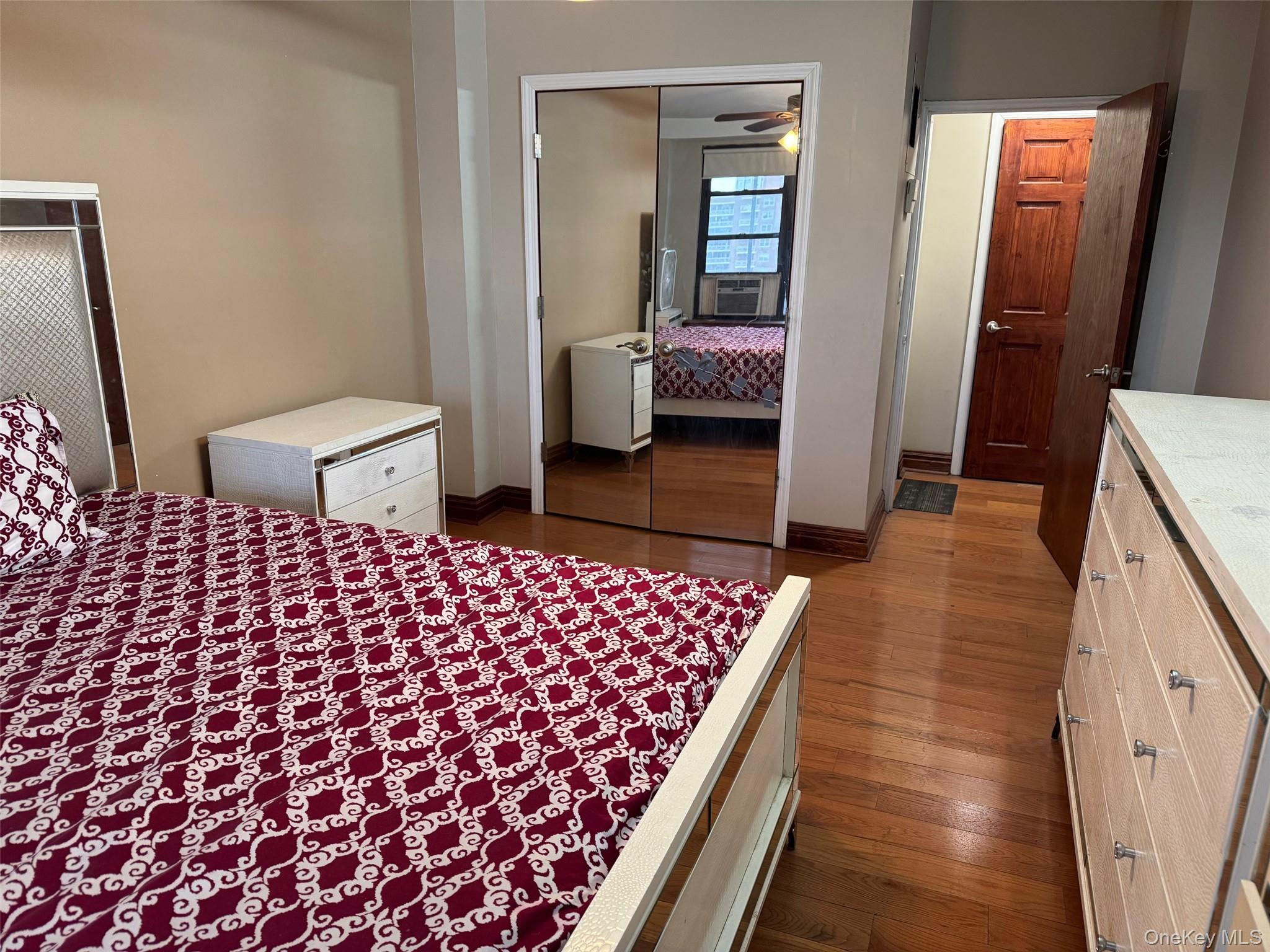 61-55 98th Street, Unit 14L Queens, NY 11374 - Photo 13 of 18 Bedroom with dark wood-type flooring, cooling unit, and a closet
