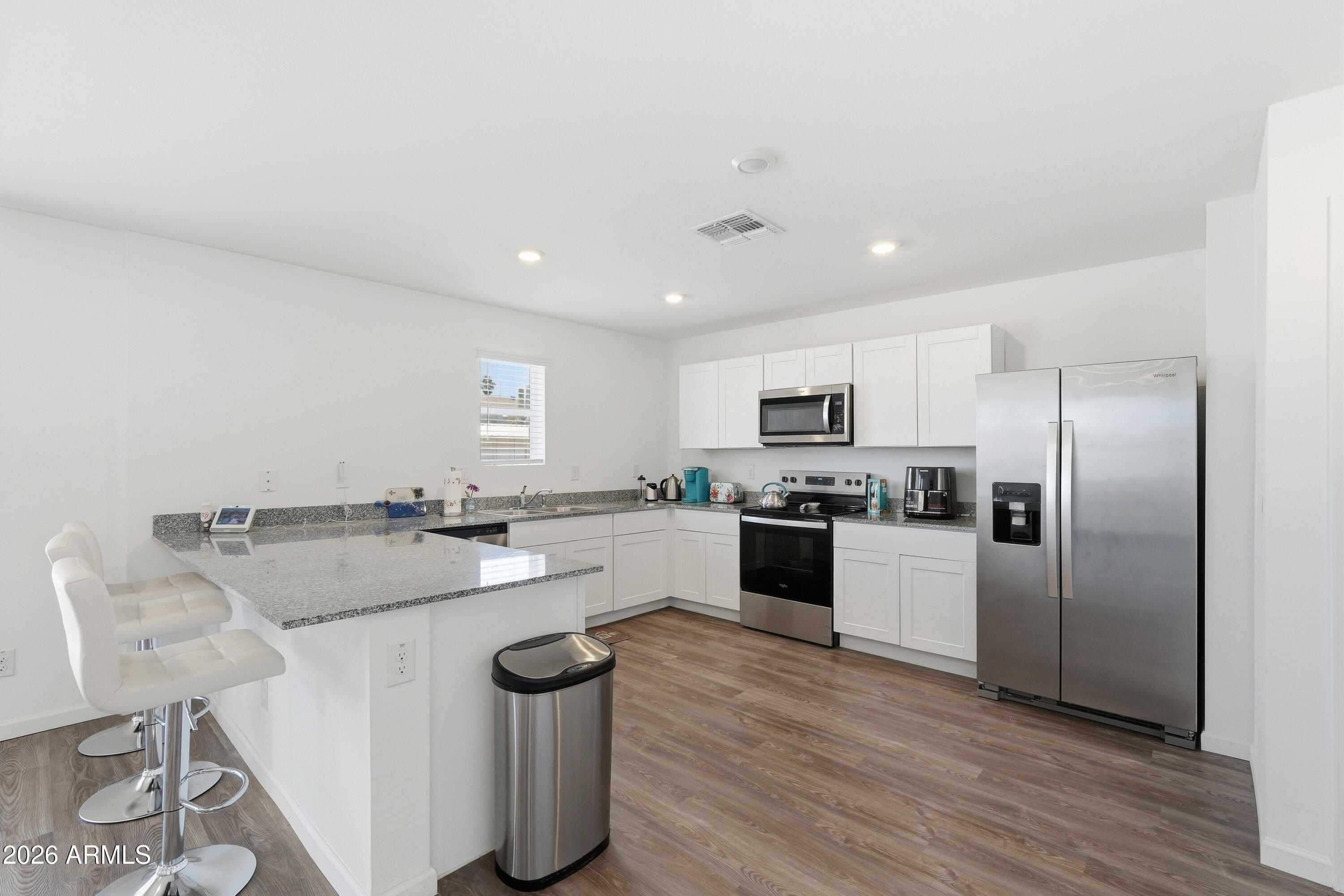 15610 South Moon Valley Road Arizona City, AZ 85123 - Photo 11 of 36 a kitchen with sink refrigerator and microwave