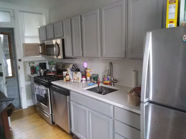 a white refrigerator freezer sitting inside of a kitchen