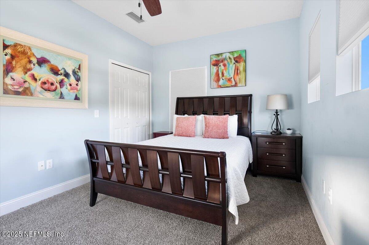 53 Menendez Road St. Augustine, FL 32080 - Photo 20 of 33 a bedroom with a bed and a painting on the wall