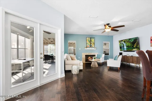 a living room with furniture fireplace and a large window