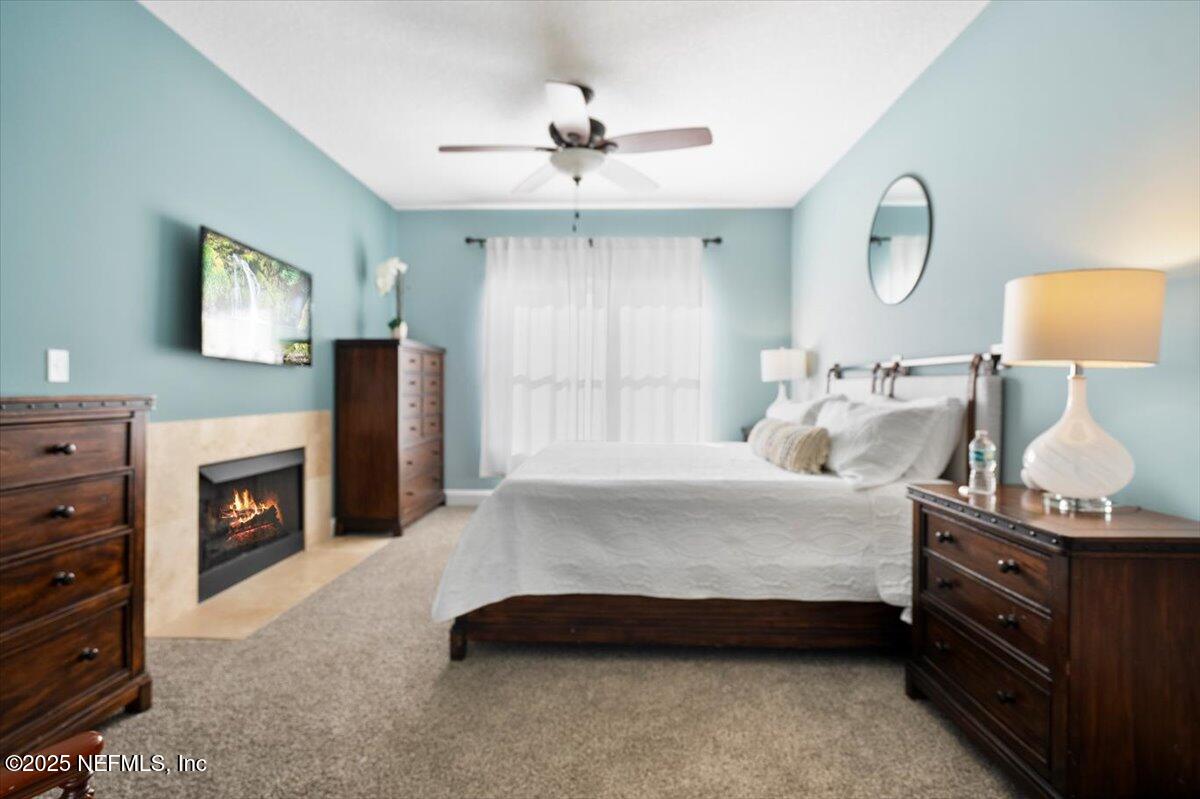 53 Menendez Road St. Augustine, FL 32080 - Photo 5 of 33 a spacious bedroom with a bed and a flat tv screen on dresser