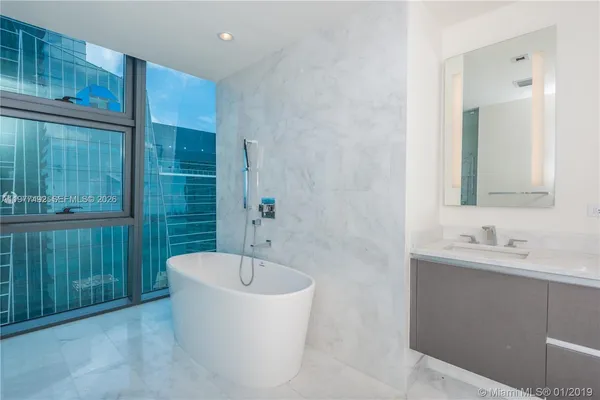 a bathroom with a bathtub and shower