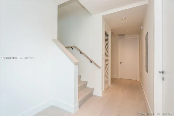 a view of a hallway with staircase