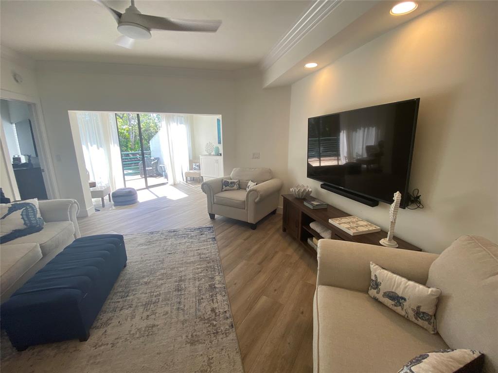 2286 Anchorage Lane, Unit A Naples, FL 34104 - Photo 11 of 41 a living room with furniture and a flat screen tv