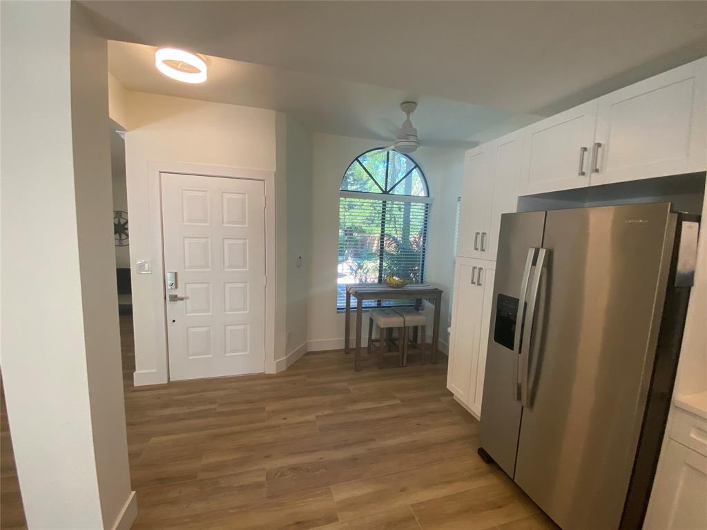 2286 Anchorage Lane, Unit A Naples, FL 34104 - Photo 15 of 41 a view of a kitchen with furniture a refrigerator and wooden floor