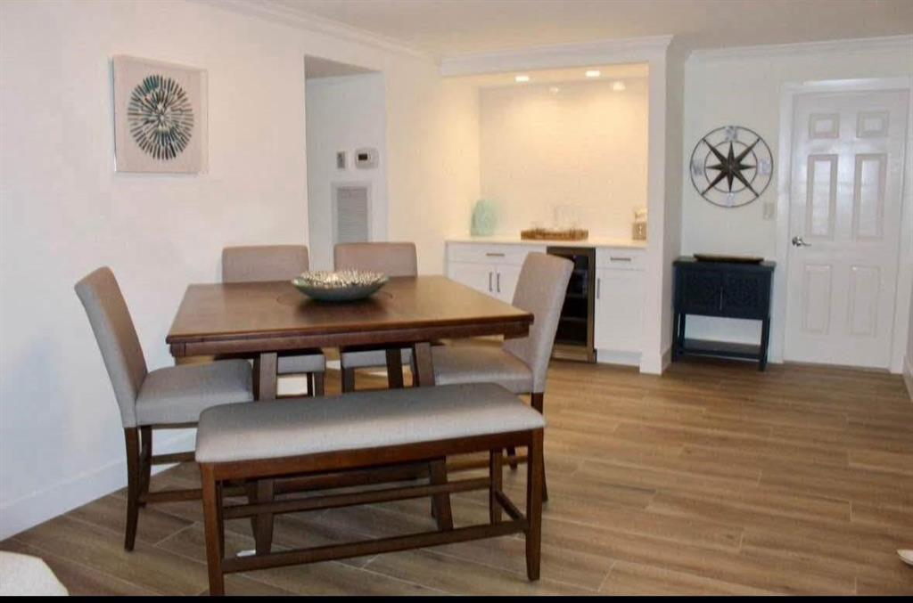 2286 Anchorage Lane, Unit A Naples, FL 34104 - Photo 16 of 41 a view of a dining room with furniture and wooden floor