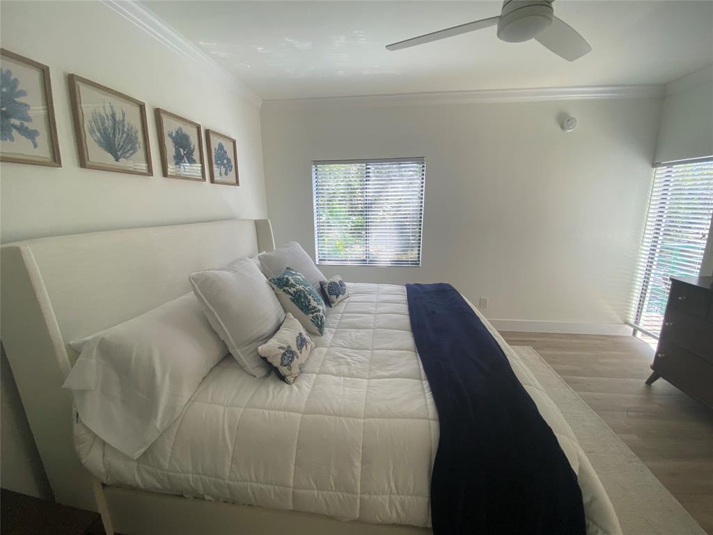 2286 Anchorage Lane, Unit A Naples, FL 34104 - Photo 18 of 41 a bedroom with a bed and window