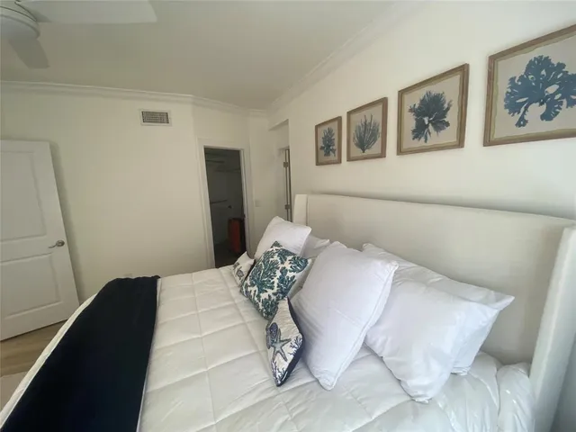 a bedroom with a bed and wall painting