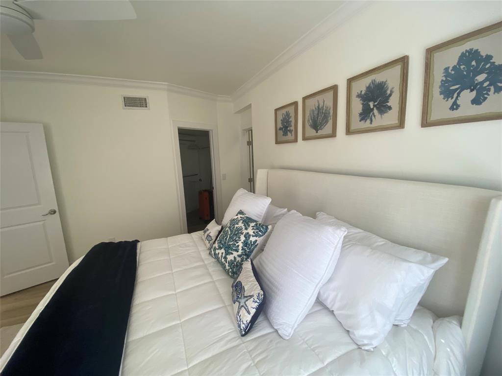 2286 Anchorage Lane, Unit A Naples, FL 34104 - Photo 20 of 41 a bedroom with a bed and wall painting