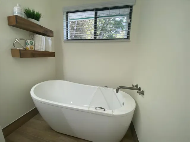 a white tub sitting next to a window
