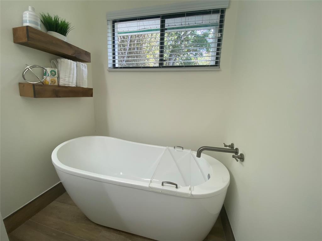 2286 Anchorage Lane, Unit A Naples, FL 34104 - Photo 25 of 41 a white tub sitting next to a window