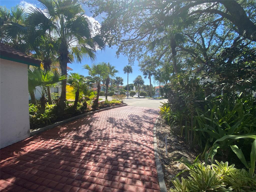 2286 Anchorage Lane, Unit A Naples, FL 34104 - Photo 35 of 41 a view of road with large trees