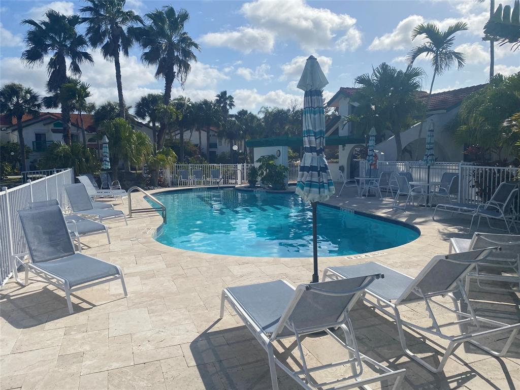 2286 Anchorage Lane, Unit A Naples, FL 34104 - Photo 38 of 41 a view of a patio with swimming pool